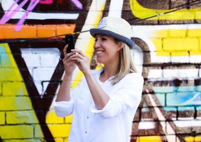Female guest smiling taking photo Brown Brothers Summer of Prosecco Pop-Up Beach Bar