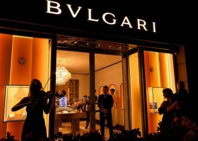 Violin player serenading guests as they enter the Bulgari Store