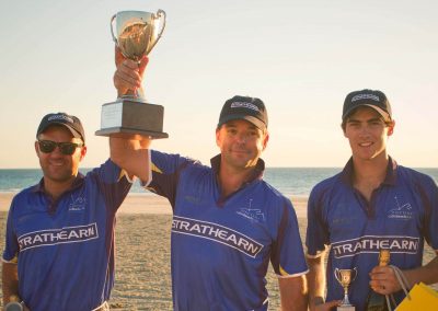 Players holding cup Cable Beach Broome Polo Tournament