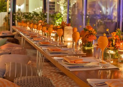 Dining table set orange theme colour Clicquot Beach House