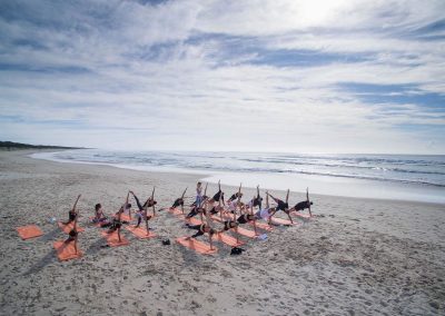 Group yoga at beach Clicquot Beach House