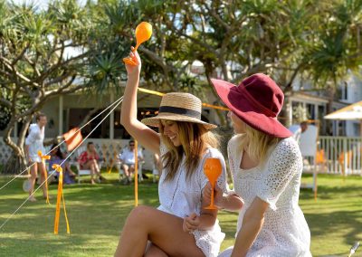 2 female models holding goblets Clicquot Beach House