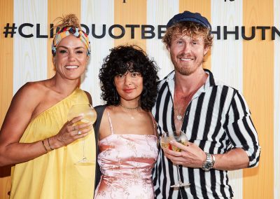 Guests smiling posing Clicquot Beach Hut at Bondi Beach event