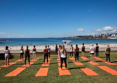 Group people yoga outdoors Clicquot Beach Hut at Bondi Beach event