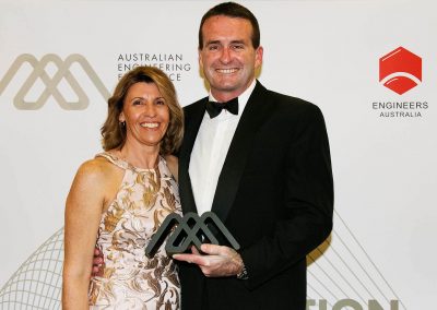 Female and male holding award Engineering Excellence Awards Roadshow