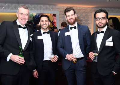 Men smiling holding drink Engineering Excellence Awards Roadshow