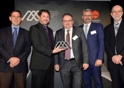 Group of men holding award Engineering Excellence Awards Roadshow