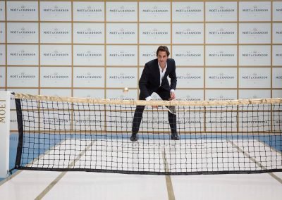Roger Federer holding tennis racket at Moet event