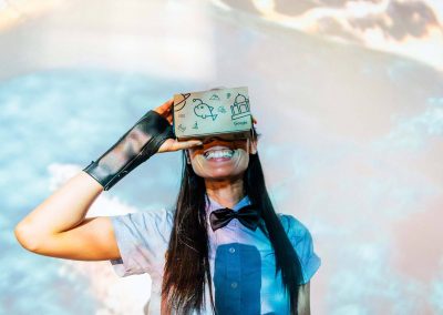 Smiling woman looking in VR headset Google Summer Party event