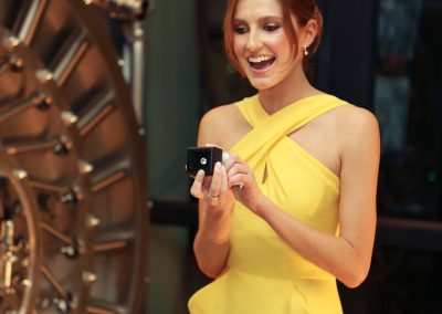 Smiling model yellow dress holding jewellery box Hardy Brothers 160th Anniversary Celebration Dinner