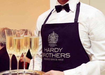 Waiter holding tray drinks Hardy Brothers 160th Anniversary Celebration Dinner