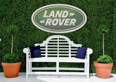 Land Rover logo green wall wooden bench Land Rover Polo Club for Polo in the City English Polo Garden