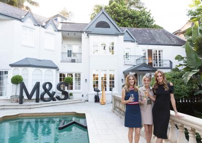 Kate Waterhouse, Nadia Fairfax and Rebecca Judd holding glasses next to swimming pool Marks & Spencer Australian Online Store launch