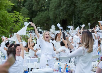 Guests cheering Moet Dinner en Blanc National Sponsorship Activation