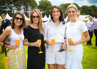 4 female guests holding drinks posing Paspaley Polo in the City Series Australia