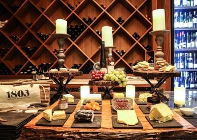 Cheese fruit on platters wine bottles background Pubmatic Ad Revenue Wolgan Valley Conference