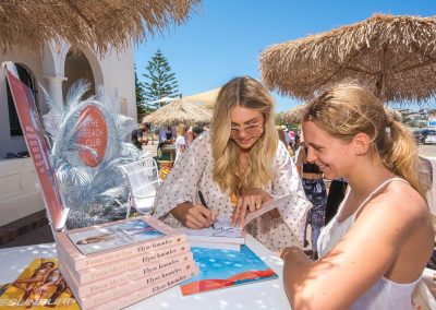 Elyse Knowles autographing book at the Seafolly Beach Club launch