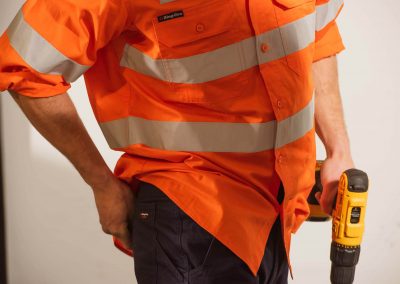Model high vis shirt holding drill Workwear Industrial Brands Roadshow