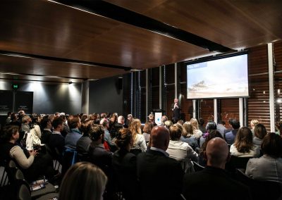 Speaker and audience at Australian Energy Market Commission Annual Staff Day